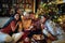 Cheerful mather and her daughter together for Christmas in front of a decorated x-mas tree