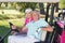 Cheerful mature golfer couple sitting in golf buggy