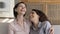 Cheerful mature mom and happy daughter excited with funny conversation