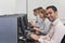 Cheerful mature student sitting in computer class