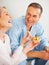 Cheerful mature woman feeding muffin to her husband. Portrait of a cheerful mature woman feeding muffin to her husband.