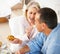 Cheerful mature woman feeding Muffin to husband. Portrait of a cheerful mature woman feeding Muffin to husband.