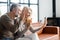 Cheerful middle-aged couple using smartphone for video connection