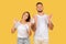 Cheerful millennial european lady and guy, show ok gesture with hands, meditation