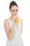 Cheerful model in white dress drinking orange juice