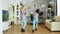 Cheerful mother and daughter dancing in living room