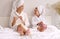 Cheerful mother and daughter filing nails on bed