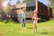 Cheerful mother and daughter playing with hula-hoops