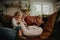 Cheerful mother and daughter tickling and playing at home on couch