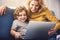 Cheerful mother enjoying exploiting computer with son