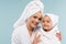 cheerful mother and kid in bathrobes