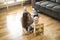 Cheerful mother playing with his baby girl on floor at living room