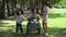 Cheerful mother with two cute daughter in park