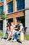 cheerful multicultural couples resting on bench together