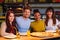 Cheerful multiracial friends having fun eating in pizzeria.