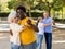 Cheerful multiracial middle aged and older adults enjoying dancing in pairs outdoor at park