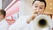 Cheerful musician plays trombone with band in mall hall