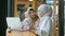 Cheerful muslim female worker giving high five in coffee shop