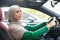 Cheerful muslim woman driving her new car