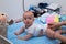 Cheerful newborn playing on the diaper table