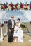 Cheerful newlyweds at beach wedding ceremony