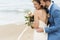 Cheerful newlyweds at beach wedding ceremony