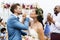 Cheerful newlyweds at beach wedding ceremony