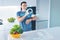 Cheerful nutritionist smiling and using modern technologies