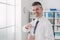 Cheerful office worker holding a water bottle