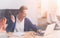 Cheerful office worker sitting at the table