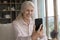 Cheerful older grandmother woman talking to family on video call