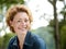 Cheerful older woman smiling outdoors