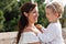 Cheerful parent holding baby daughter outdoors