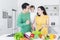 Cheerful parents and child making salad