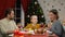 Cheerful parents and daughter eating fresh salad on Xmas eve, holiday together