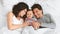 Cheerful parents having fun with their baby boy in bed