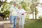 Cheerful pensioners looking for the place for picnic outdoors