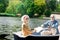 Cheerful pensioners smiling and enjoying boating together