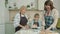 Cheerful people mom, granny and child making biscuits at home and talking