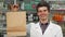 Cheerful pharmacist holding shopping bag smiling to the camera