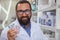 Cheerful pharmacist selling medication at his drugstore