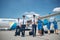 Cheerful pilots and flight attendants carrying travel bags at airport