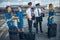 Cheerful pilots and stewardesses chatting on the street