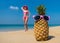 Cheerful pineapple glasses and a woman in a bikini sunbathing on the beach on sea backgrounde beach on sea background.