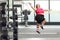 Cheerful plus size woman exercising at a gym