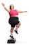 Cheerful plus size woman exercising step aerobics
