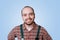 cheerful portrait, a happy bearded workman is captured against a stunning blue background,