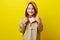 Cheerful portrait of happy little girl in demi-season beige jacket with hood from rain, studio shot on colored