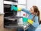 Cheerful positive adult girl removing snuff in oven