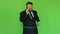 Cheerful and positive bearded man in suit with hula hoop talking on phone. Funny situation. Chromakey Green. Bearded
